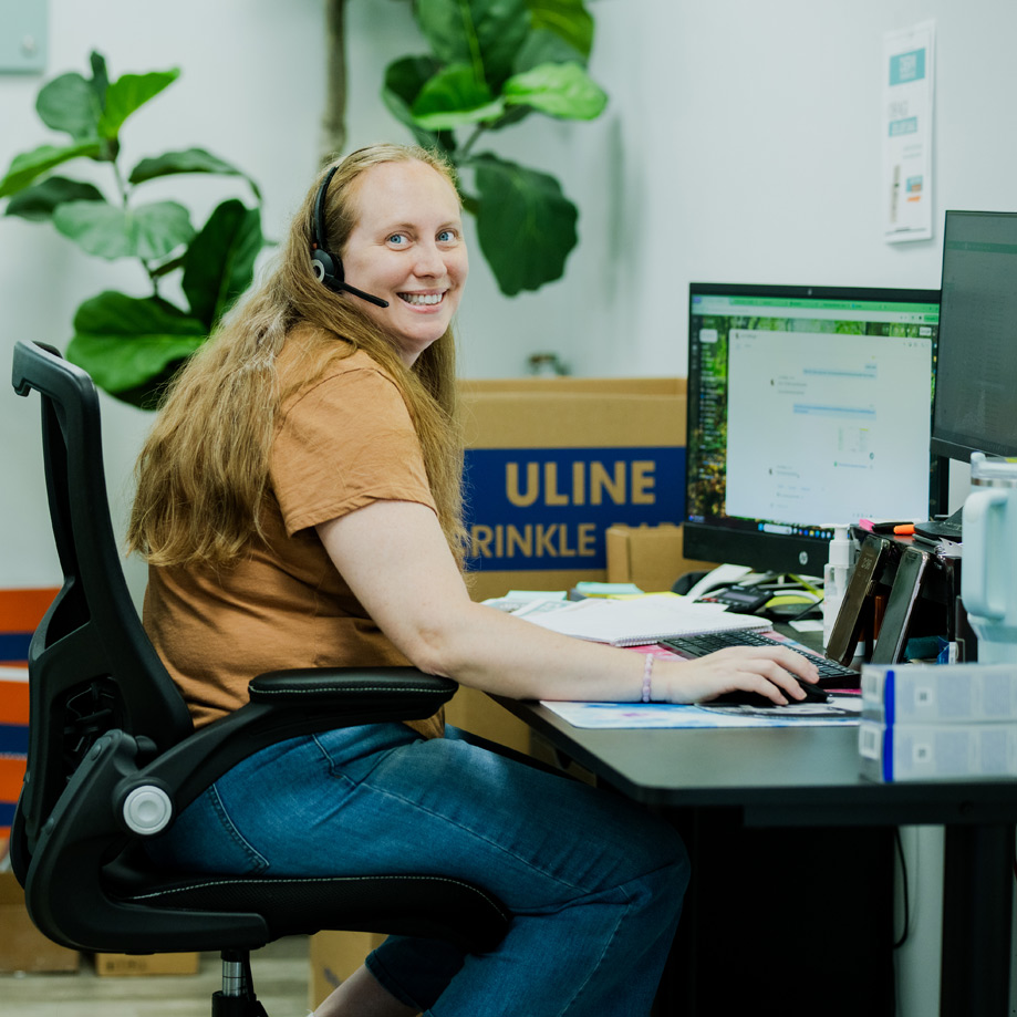 Smiling Employee working at desk at taylor station logistics Smiling Employee working at desk at taylor station logistics