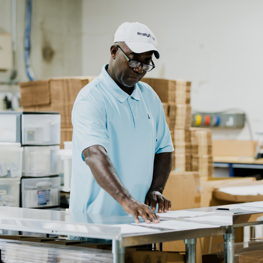 Employee standing in warehouse organizing products Employee standing in warehouse organizing products